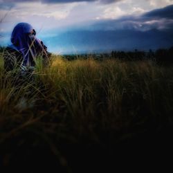 Scenic view of grass on field against sky