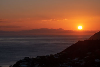 Scenic view of sea against romantic sky at sunset