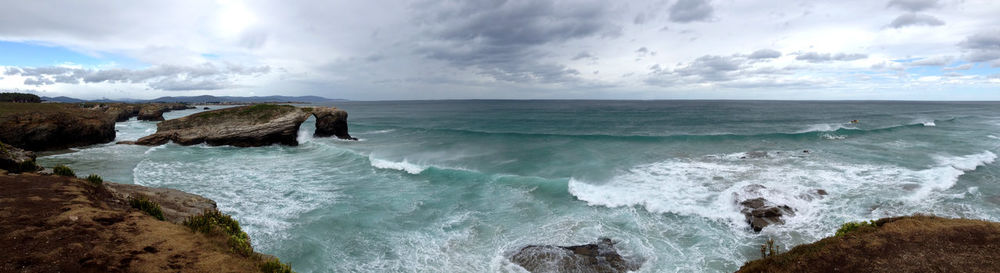 Scenic view of sea against cloudy sky