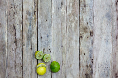 Close-up of sliced limes on wooden table
