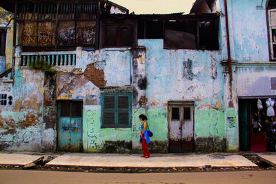 Woman standing in front of built structure