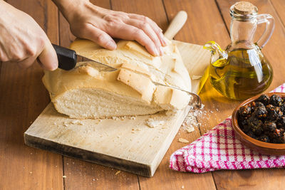 Cropped hands of person preparing food on table