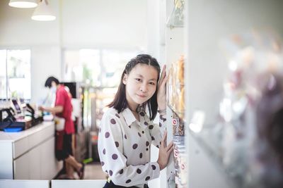 Portrait of woman standing at store