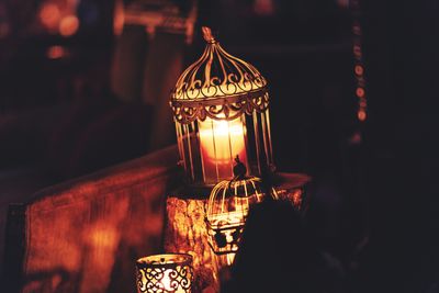 Close-up of illuminated candles on table