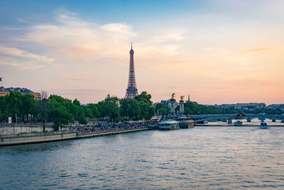 View of city at waterfront during sunset