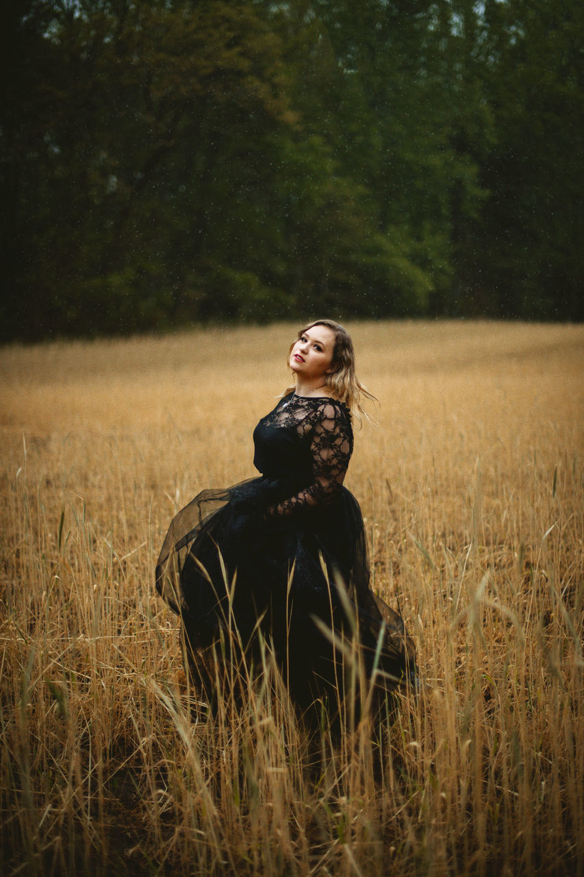 one person, plant, adult, women, nature, land, clothing, field, landscape, grass, sitting, rural scene, young adult, portrait, fashion, hairstyle, tree, emotion, long hair, outdoors, tranquility, environment, three quarter length, smiling, autumn, morning, beauty in nature, lifestyles, female, happiness, contemplation, leisure activity, looking, dress, forest, day, sky, hat, meadow, solitude, full length, tranquil scene, looking away, elegance