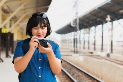 Portrait of woman photographing camera
