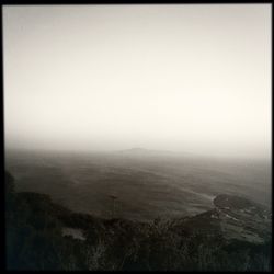 Scenic view of landscape against sky during foggy weather