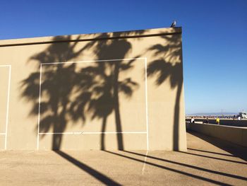 Shadow of building against clear sky