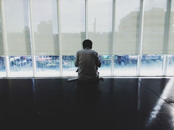 Businessman looking out through office window