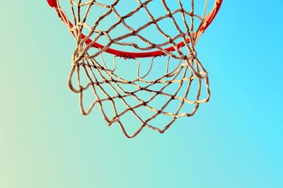 Low angle view of basketball hoop against clear blue sky