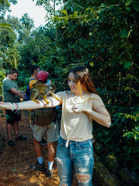 People standing against plants and trees