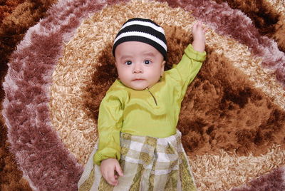 Portrait of cute baby girl lying down