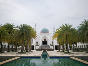 View of swimming pool by building against sky