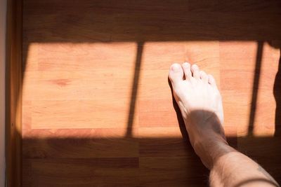 Low section of man on hardwood floor