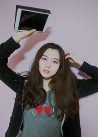 Portrait of young woman using mobile phone