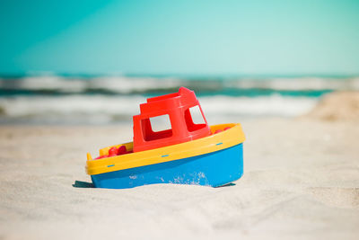 Toy ship on the beach in the summer