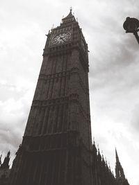 Low angle view of building against cloudy sky