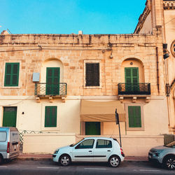 Cars on road against buildings in city