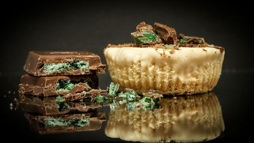 Close-up of cake on table against black background