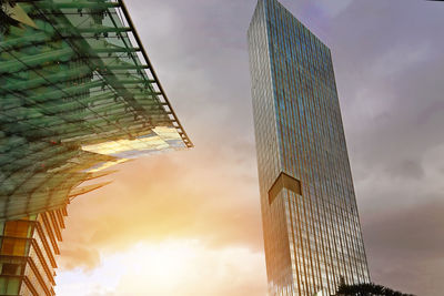 Low angle view of modern buildings against sky during sunset