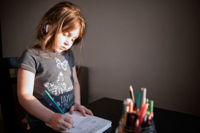 Close-up of girl holding table at home