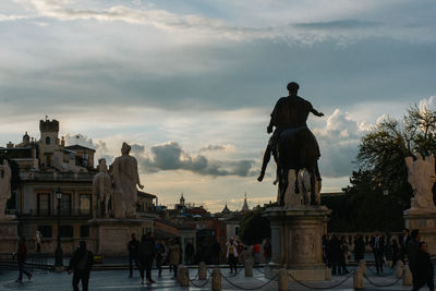 Statue against sky in city