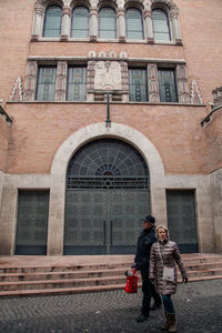 Full length of man standing against building