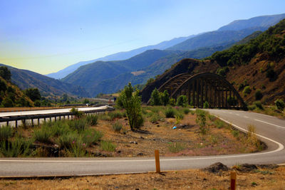 Road by mountain against sky