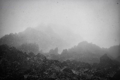 Scenic view of mountains against sky during foggy weather