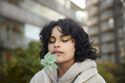 Teenage girl blowing on pinwheel