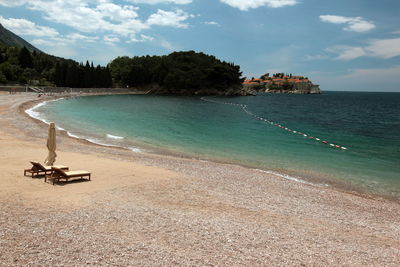 Lounge chair and beach umbrella on beach