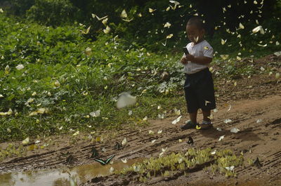 Full length of boy standing on field