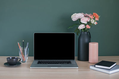 Flower vase on table at home