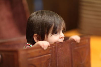 Cute boy in treasure chest at home