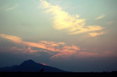 Scenic view of silhouette mountain against sky at sunset