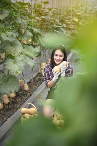 Portrait of smiling young woman standing outdoors