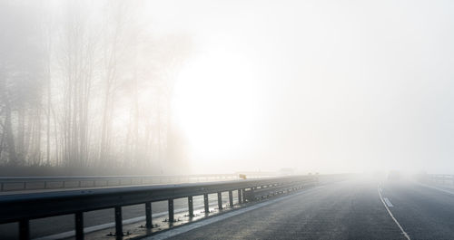 Bridge over road against sky during winter