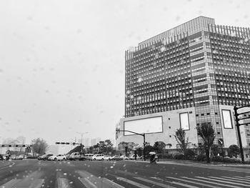 Vehicles on road against buildings in city