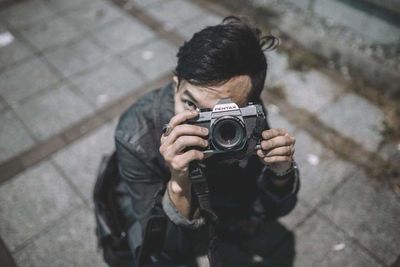 Man photographing with camera on street