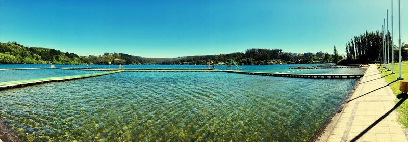 Scenic view of swimming pool against clear blue sky