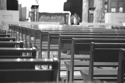 Empty chairs and table in building