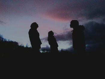 Silhouette of people against sky during sunset