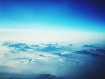 Scenic view of mountains against blue sky