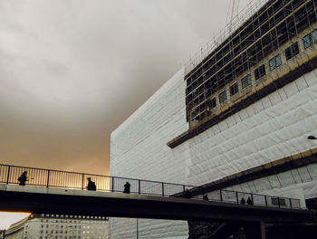 Low angle view of building against cloudy sky