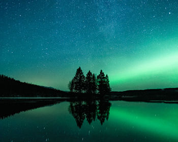 Scenic view of lake against sky at night