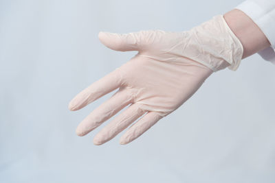 Close-up of person hand over white background