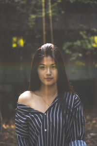 Portrait of young woman standing outdoors