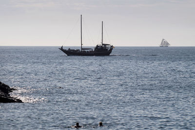 Sailboat sailing on sea against sky