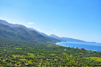 Scenic view of mountains against blue sky